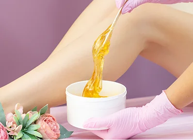young-woman-having-hair-removal-procedure-leg-with-sugaring-paste-salon