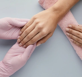 Close up manicurist holding customer hand