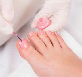 Woman getting her toenails painted